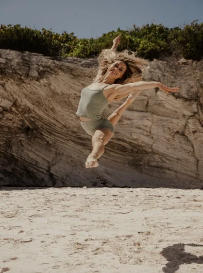 Lindsey leaping on the beach